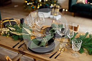 Table served for Christmas dinner in living room, close-up view, table setting, Christmas decoration