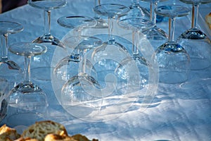 Table served outside in garden with many empty wine glasses for party, celebration or wine tasting