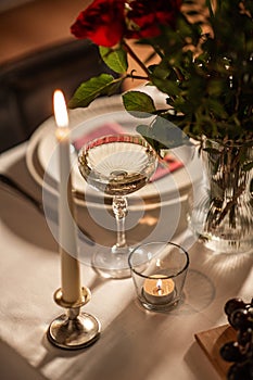 table serving with champagne in glass and candle