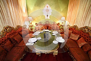 Table with serving and sofas in eastern restaurant