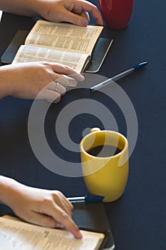 Table Set for a Bible Study as People Search the Scriptures