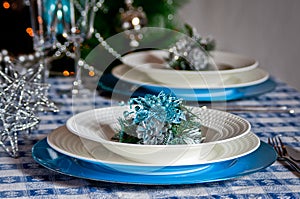 Table set for christmas dinner with decoration blue and silver