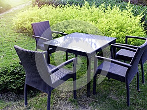 Table set with modern rattan chairs and glass dining table.