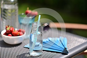 Table set with water and strawberries