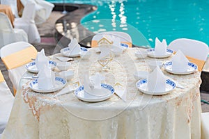 Table set for wedding or another catered event dinner, luxury wedding table setting for fine dining at outdoors.