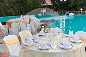 Table set for wedding or another catered event dinner, luxury wedding table setting for fine dining at outdoors.