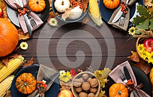 Table setting with autumn vegetables and fruits on wooden background, flat lay. Thanksgiving day celebration