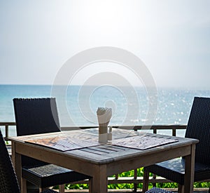 Table setting at beach restaurant, sea view and sky background