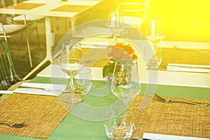 Table setting with blank guest card on empty white plate and cutlery on table, copy space. Menu mockup, place setting at wedding