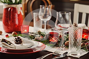 Table setting for celebration Christmas and New Year Holidays. Festive table in classic red and green at home with rustic details