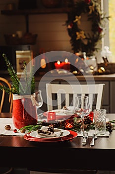 Table setting for celebration Christmas and New Year Holidays. Festive table in classic red and green at home with rustic details