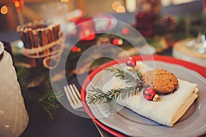 Table setting for celebration Christmas and New Year Holidays. Festive table in classic red and green at home with rustic details