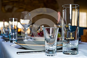 Table setting. Cutlery. Glass, stack, bowls and fork on the table