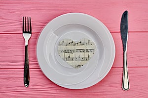 Table setting with cutlery and paper heart.