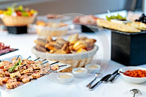 Table setting with delicious dishes made with meat and vegetables ready for a birthday party