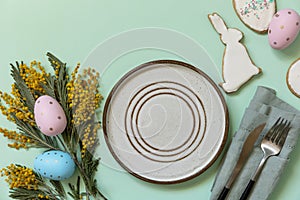 Table setting for Easter dinner with easter eggs and mimosa