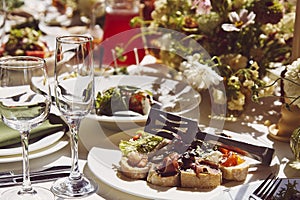 Table setting within the elegant chamber mood, under captivating shadows. The wedding style channels Provence's