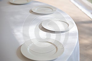 Table setting element empty plates with cutlery on white tablecloth