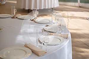 Table setting element empty plates with cutlery on white tablecloth