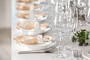 Table setting with empty glasses, plates and cutlery