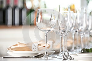 Table setting with empty glasses, plates and cutlery