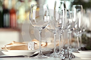 Table setting with empty glasses, plates and cutlery