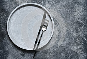 Table setting. Empty plate, knife, fork and napkin. Top view and flat lay with copy space