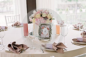 Table setting with flowers and candles at a luxurious wedding reception