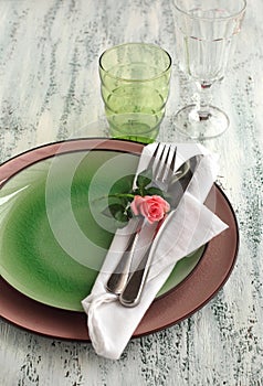 Table setting with fork, knife, plates, and napkin