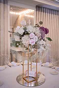 Table setting at a luxury wedding reception. Beautiful flowers on the table.