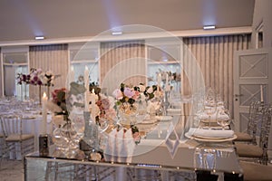 Table setting at a luxury wedding reception. Beautiful flowers on the table.