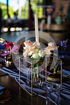 Table setting at a luxury wedding reception. Beautiful flowers on the table.