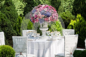 Table setting at a luxury wedding reception in the garden