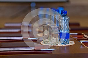 Table setting for meetings. mineral water, folder, pen.