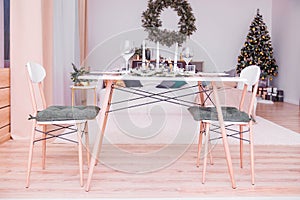 Table setting in the New Year`s style. Simple and stylish interior rooms in the New Year`s style