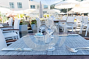 Table setting outdoor terrace. Nobody in the picture just table setup with cutlery and glasses