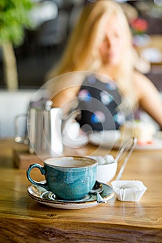 Restaurant, lunch time. Silhouette of a woman. Coffee time.