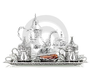 Table setting with silver tableware. Oriental hospitality