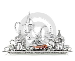 Table setting with silver tableware. Oriental hospitality photo