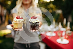 Table setting, tea party, woman shows fresh cakes