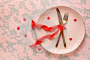 Table setting for Valentines Day celebration on color background