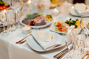 Table setting at a wedding banquet. Decoration flowers