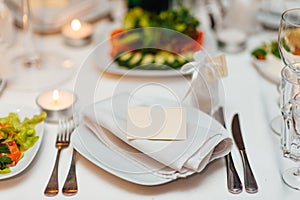 Table setting at a wedding banquet. Decoration flowers