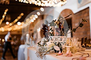 Table setting for wedding party decor flowers lights blurred background