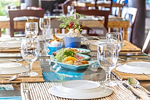 Table setup in outdoor cafe, small restaurant in a hotel, summer