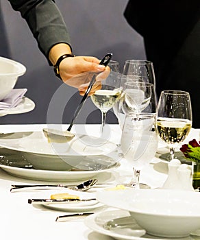 Table side service at a fine dining restaurant, Waiter serving dishes to the table