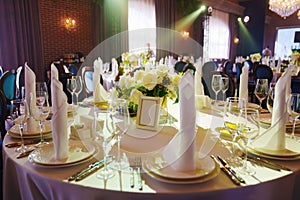 table with sign for number or names of guests in banquet hall of restaurant.