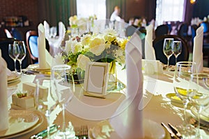 table with sign for number or names of guests in banquet hall of restaurant.