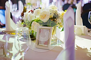 table with sign for number or names of guests in banquet hall of restaurant.