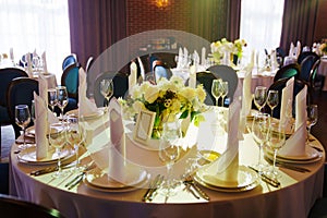 table with sign for number or names of guests in banquet hall of restaurant.